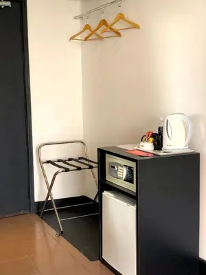 a small kitchen with a black counter and a chair at Flamingo Hotel By The Lake, Kuala Lumpur in Kuala Lumpur
