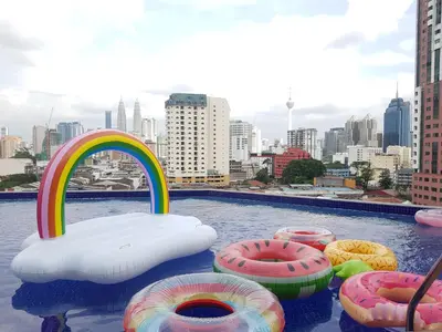 a swimming pool with a rainbow and inflatables in a city at WTC Hotel, Kuala Lumpur - Formerly Leo Palace Hotel Classic Wing in Kuala Lumpur
