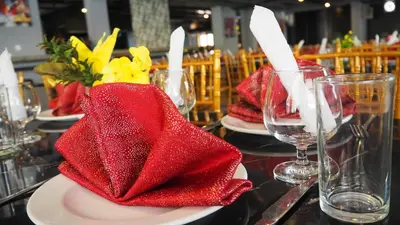 a table with red napkins and wine glasses on it at WTC Hotel, Kuala Lumpur - Formerly Leo Palace Hotel Classic Wing in Kuala Lumpur