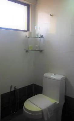 a bathroom with a white toilet and a window at WTC Hotel, Kuala Lumpur - Formerly Leo Palace Hotel Classic Wing in Kuala Lumpur