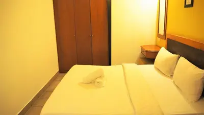 a hotel room with a bed with a towel on it at WTC Hotel, Kuala Lumpur - Formerly Leo Palace Hotel Classic Wing in Kuala Lumpur