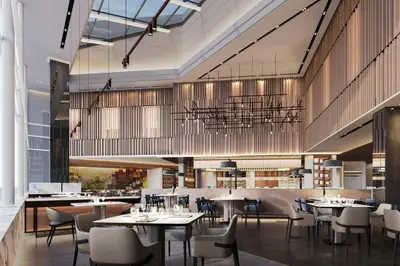 a restaurant with tables and chairs and a chandelier at Petaling Jaya Marriott Hotel in Petaling Jaya