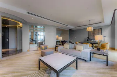 a living room with a couch and a table at Hilton Kuala Lumpur in Kuala Lumpur