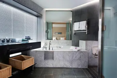 a bathroom with a tub and a sink at Hilton Kuala Lumpur in Kuala Lumpur