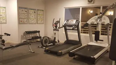 a gym with two exercise bikes and a treadmill at Holiday Place Kuala Lumpur in Kuala Lumpur