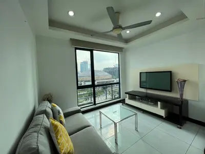 a living room with a couch and a flat screen tv at Casa Residency Apartment in Kuala Lumpur