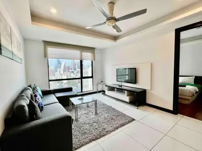 a living room with a couch and a flat screen tv at Casa Residency Apartment in Kuala Lumpur