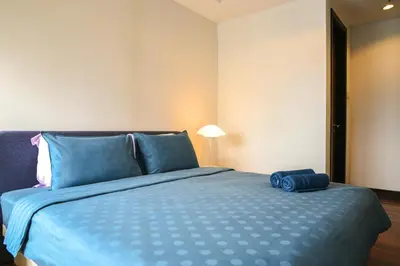 a bedroom with a blue bed with a blue bag on it at Casa Residency Apartment in Kuala Lumpur