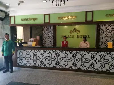three people standing at a bar in a lobby at Palace Hotel in Kuala Lumpur