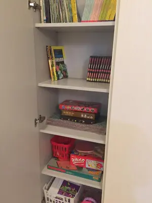 a book shelf filled with toys and books at Homely Apartment with Great Facilities and Free Parking in Kuala Lumpur