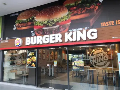 a burger king restaurant with two large hamburgers on the wall at Homely Apartment with Great Facilities and Free Parking in Kuala Lumpur