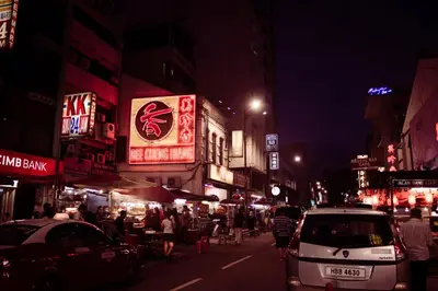 a busy city street at night with people and cars at The 5 Elements Hotel Chinatown Kuala Lumpur in Kuala Lumpur