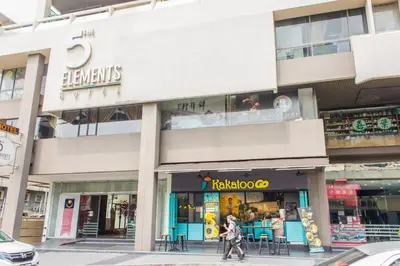 a woman walks down a street in front of a store at The 5 Elements Hotel Chinatown Kuala Lumpur in Kuala Lumpur