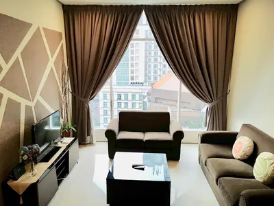 a living room with a couch and a tv at Soho Suites Klcc By Pnut KLCC VIEW in Kuala Lumpur