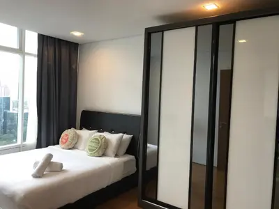 a bedroom with a bed and a large mirror at VORTEX SUITES KLCC by PNUT With NETFLIX in Kuala Lumpur