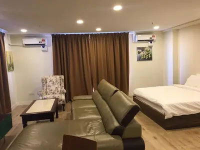 a bedroom with a couch and a bed and a chair at Arina Unity in Kuala Lumpur
