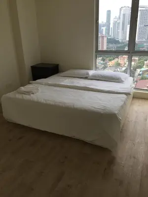 a large bed in a room with a large window at Arina Unity in Kuala Lumpur