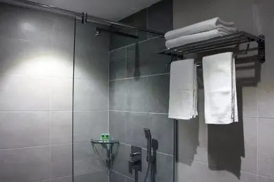 a bathroom with a shower with a glass shower stall at Ahyu Hotel in Kuala Lumpur