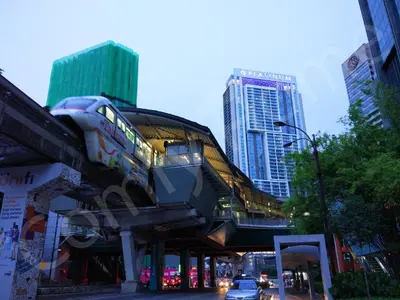 a building with a train on it in a city at 5 STAR & LUXURY Apartment near KLCC/ KL City Centre in Kuala Lumpur