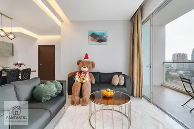 a teddy bear sitting on a couch in a living room at Regalia Residence @ KLCC View Sky Pool by MC in Kuala Lumpur