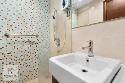 a bathroom with a white sink and a shower at Regalia Residence @ KLCC View Sky Pool by MC in Kuala Lumpur