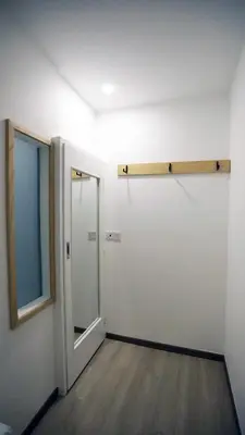 an empty room with a door and a mirror at Vivids Hotel in Kuala Lumpur