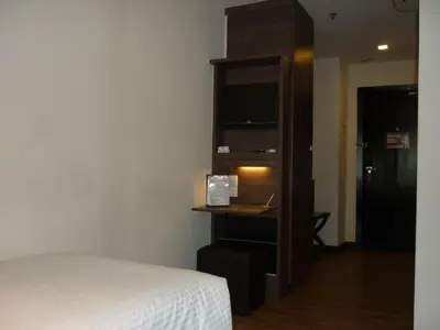 a bedroom with a bed and a tv in a room at Frenz Hotel Kuala Lumpur in Kuala Lumpur