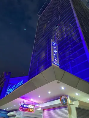a store with neon signs on the side of a building at Frenz Hotel Kuala Lumpur in Kuala Lumpur