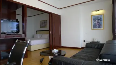 a living room with a couch and a bed at Sunbow Suites @ Times Square Kuala Lumpur in Kuala Lumpur