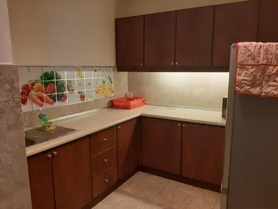 a kitchen with wooden cabinets and a sink at Genius Service Suites at time square kl in Kuala Lumpur