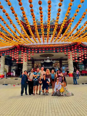 a group of people standing in front of a building at Travelogue Guest House in Kuala Lumpur