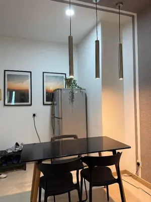 a table and chairs in a room with a refrigerator at Parkview Suite KLCC, Myhomey in Kuala Lumpur