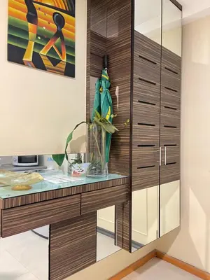 a dressing room with a desk and a glass cabinet at Parkview Suite KLCC, Myhomey in Kuala Lumpur