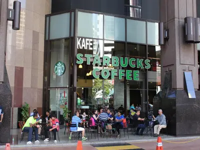 a group of people sitting in front of a starbucks coffee shop at FnF Suite @ Time Square in Kuala Lumpur