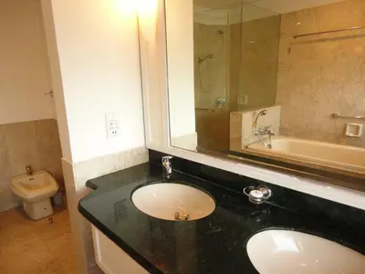 a bathroom with a sink and a tub and a toilet at FnF Suite @ Time Square in Kuala Lumpur