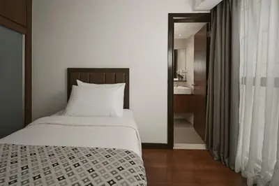 a bedroom with a large bed and a bathroom at TRILLION SUITES by SLG in Kuala Lumpur