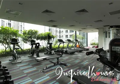 a gym with rows of tread machines in a building at Inspired Homes @ Summer Suite in Kuala Lumpur