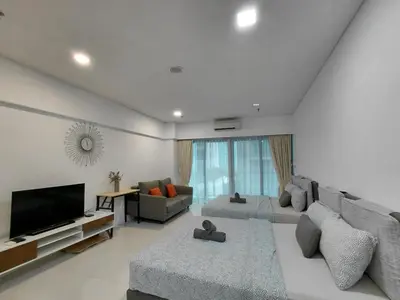 a living room with a large couch and a television at Inspired Homes @ Summer Suite in Kuala Lumpur
