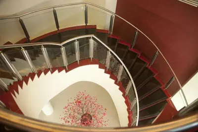 a spiral staircase in a building with flowers on it at Hotel Sentral Pudu @ City Centre / Bukit Bintang in Kuala Lumpur
