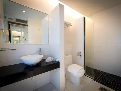 a bathroom with a sink and a toilet and a mirror at Hotel Sentral Pudu @ City Centre / Bukit Bintang in Kuala Lumpur