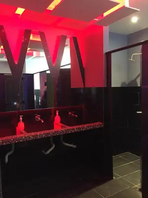 a mirror in a bathroom with red lighting at Space Hotel @ Chinatown Kuala Lumpur in Kuala Lumpur