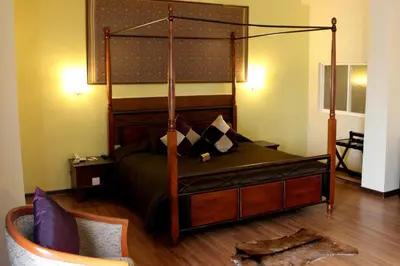 a bedroom with a bed with a four post canopy at Hotel Maluri in Kuala Lumpur