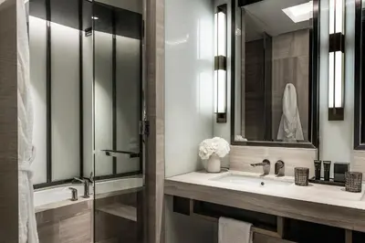 a bathroom with a sink and a mirror at Four Seasons Hotel Kuala Lumpur in Kuala Lumpur