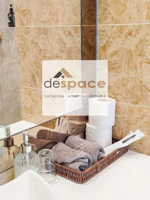 a basket of towels sitting on top of a bathroom sink at Dorsett Bukit Bintang Residence by De Space in Kuala Lumpur