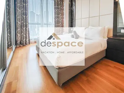 a room with a large bed with a sign on it at Dorsett Bukit Bintang Residence by De Space in Kuala Lumpur
