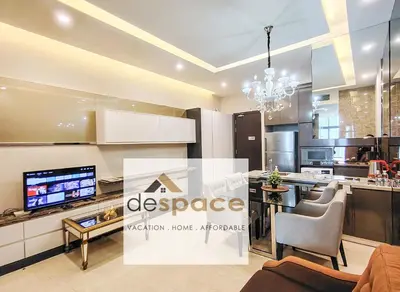 a living room with a kitchen with a tv at Dorsett Bukit Bintang Residence by De Space in Kuala Lumpur