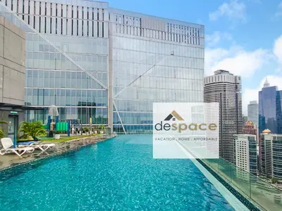 a view of a pool in front of a building at Dorsett Bukit Bintang Residence by De Space in Kuala Lumpur