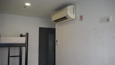 a room with a tv on the ceiling of a room at Leo Backpackers @ Central Market in Kuala Lumpur