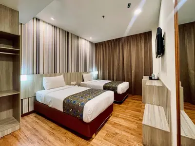 a hotel room with two beds and a television at My Hotel @ Bukit Bintang in Kuala Lumpur