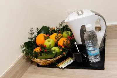 a basket of fruit on a counter with a water bottle at My Hotel @ Bukit Bintang in Kuala Lumpur